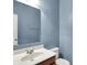 Bathroom featuring a white sink vanity, toilet, large mirror, and soft blue walls at 1384 Horse Shoe, Greenwood, IN 46143