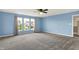 This bedroom has large windows, neutral carpeting, and a ceiling fan providing optimal lighting at 1384 Horse Shoe, Greenwood, IN 46143