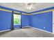 Bright bedroom featuring blue walls, neutral carpet, and a ceiling fan for added comfort at 1384 Horse Shoe, Greenwood, IN 46143