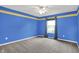 Bright bedroom featuring blue walls, neutral carpet, and a ceiling fan for added comfort at 1384 Horse Shoe, Greenwood, IN 46143