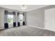The bedroom has two windows, neutral gray walls, and gray carpeting throughout at 1384 Horse Shoe, Greenwood, IN 46143