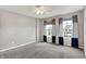 The bedroom features neutral gray walls with large windows, and a ceiling fan for brightness at 1384 Horse Shoe, Greenwood, IN 46143