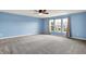 Spacious bedroom with neutral carpet, blue walls, bright window, and modern ceiling fan at 1384 Horse Shoe, Greenwood, IN 46143