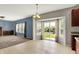 Open dining and living space filled with natural light featuring wood cabinets and sliding doors to the backyard at 1384 Horse Shoe, Greenwood, IN 46143