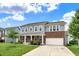 Charming two-story home featuring gray siding, brick accents, a well-manicured lawn, and an attached two-car garage at 1384 Horse Shoe, Greenwood, IN 46143