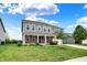 Charming two-story home featuring gray siding, brick accents, a well-manicured lawn, and an attached two-car garage at 1384 Horse Shoe, Greenwood, IN 46143