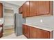 Kitchen with wood cabinets, granite countertops, stainless steel refrigerator, and access to mudroom at 1384 Horse Shoe, Greenwood, IN 46143