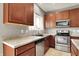 Well-equipped kitchen with stainless steel appliances, granite countertops and dark cabinetry for the home chef at 1384 Horse Shoe, Greenwood, IN 46143