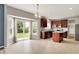Open kitchen and dining area with dark wood cabinets, stainless appliances, and sliding doors to the backyard at 1384 Horse Shoe, Greenwood, IN 46143