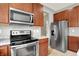 Updated kitchen features stainless steel appliances, granite countertops, and dark cabinetry for a modern look at 1384 Horse Shoe, Greenwood, IN 46143