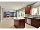 Open kitchen with island, wood cabinets, stainless steel appliances, and view of living room with fireplace at 1384 Horse Shoe, Greenwood, IN 46143