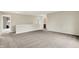 Spacious living room with neutral carpet, white walls, staircase access, and open entryway at 1384 Horse Shoe, Greenwood, IN 46143