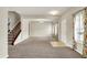 Bright, open living room with neutral tones, plush carpeting, and colorful window treatments at 1384 Horse Shoe, Greenwood, IN 46143