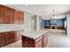 Kitchen area featuring a center island looking into the open-concept living room with a fireplace at 1384 Horse Shoe, Greenwood, IN 46143
