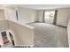 Spacious living room with neutral carpet, large windows, and staircase access at 1384 Horse Shoe, Greenwood, IN 46143