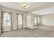 Bright living room boasting plush carpeting and abundant natural light from multiple windows at 1384 Horse Shoe, Greenwood, IN 46143