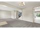 Spacious living room featuring neutral walls and carpeting, chandelier and access to stairs at 1384 Horse Shoe, Greenwood, IN 46143