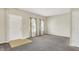 Bright and airy living room features neutral walls, plush carpeting, and large windows with floral curtains at 1384 Horse Shoe, Greenwood, IN 46143
