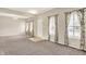 Bright and airy living room features neutral walls, plush carpeting, and large windows with floral curtains at 1384 Horse Shoe, Greenwood, IN 46143