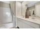 Bright bathroom with double sink vanity, white cabinets, and a shower/tub combo at 15298 Farrington Way, Fishers, IN 46037