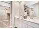 Bathroom featuring a double sink vanity, a large mirror, and a walk-in closet on the left at 15298 Farrington Way, Fishers, IN 46037