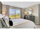Light-filled main bedroom showcasing a large window with scenic views at 15298 Farrington Way, Fishers, IN 46037