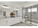 Bathroom with double vanity, large mirror, and glass-enclosed shower with seat at 15344 Cardonia Rd, Fishers, IN 46037
