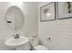 Half bathroom featuring a round mirror and a pedestal sink in a modern designed room at 15344 Cardonia Rd, Fishers, IN 46037