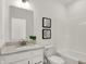 A bright bathroom showcasing a white vanity, toilet, bathtub and decorative artwork at 15344 Cardonia Rd, Fishers, IN 46037