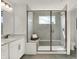 A modern bathroom featuring a glass-enclosed shower with bench seating and neutral tiling at 15344 Cardonia Rd, Fishers, IN 46037