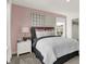 Comfortable bedroom features neutral tones, white bedding, and decorative wall art at 15344 Cardonia Rd, Fishers, IN 46037