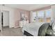 Inviting bedroom with three windows, neutral-toned walls, dresser, and views of the neighborhood at 15344 Cardonia Rd, Fishers, IN 46037