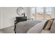 Bright bedroom featuring a large window, gray comforter, dresser with round mirror and a dark metal bed frame at 15344 Cardonia Rd, Fishers, IN 46037