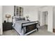 Stylishly decorated bedroom with a metal frame bed, side tables, and wood accent wall at 15344 Cardonia Rd, Fishers, IN 46037