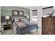 Stylish bedroom with grey accents, sports themed decor, and a large window with privacy shades at 15344 Cardonia Rd, Fishers, IN 46037
