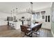 Open concept kitchen and dining area with modern lighting and seating for six at 15344 Cardonia Rd, Fishers, IN 46037