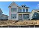 New two-story brick home featuring black-framed windows and a covered front porch with white pillars at 15344 Cardonia Rd, Fishers, IN 46037
