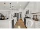 Bright kitchen featuring white cabinets, a center island, stainless steel appliances, and wood flooring at 15344 Cardonia Rd, Fishers, IN 46037