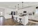 Spacious kitchen featuring an island with seating, modern lighting, and stainless steel appliances at 15344 Cardonia Rd, Fishers, IN 46037