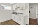 Laundry room features white cabinets, a sink, and a view to a walk-in closet at 15344 Cardonia Rd, Fishers, IN 46037