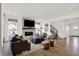 Spacious living room featuring a stone fireplace, hardwood floors, and comfortable seating arrangements at 15344 Cardonia Rd, Fishers, IN 46037