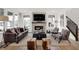 Open concept living room boasts a stone fireplace, hardwood floors and ample natural light at 15344 Cardonia Rd, Fishers, IN 46037