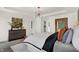 A well-lit main bedroom featuring a modern chandelier and artwork, as well as a walk-in closet at 15344 Cardonia Rd, Fishers, IN 46037