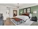 A stylish main bedroom with green accent wall, and views to the attached bathroom at 15344 Cardonia Rd, Fishers, IN 46037