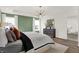A spacious main bedroom with a tray ceiling, a chandelier, and large windows at 15344 Cardonia Rd, Fishers, IN 46037