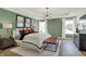 A bright main bedroom features a modern light fixture, green walls, and two large windows at 15344 Cardonia Rd, Fishers, IN 46037