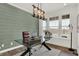 Stylish home office with a glass desk, accent wall, modern lighting, and large window at 15344 Cardonia Rd, Fishers, IN 46037