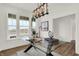 Bright home office featuring a glass desk, decorative lighting, and a large window with a view at 15344 Cardonia Rd, Fishers, IN 46037