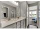 Modern bathroom with double vanity, white countertops, and ample lighting, creating a clean and bright space at 15360 Cardonia Rd, Fishers, IN 46037