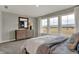 Bright bedroom featuring three large windows, a dresser with a mirror, carpeted floors, and neutral paint at 15360 Cardonia Rd, Fishers, IN 46037